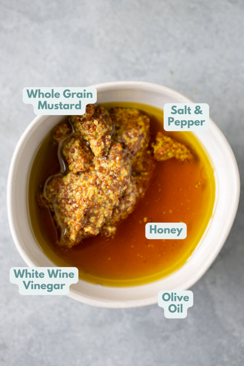 Ingredients to make honey mustard dressing in a bowl before mixing together with labels.