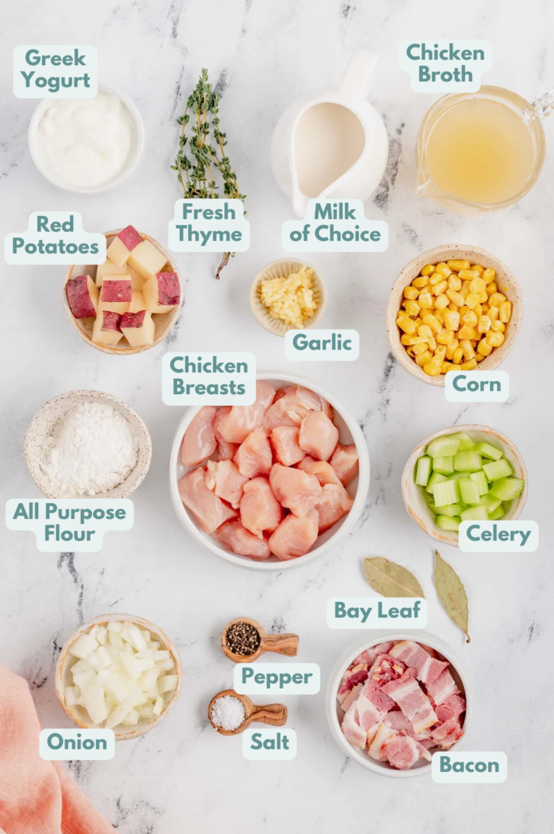 Ingredients for chicken corn chowder in white bowls: chicken breast, bacon, onion, clery, garlic, red potatoes, salt, pepper, all purpose flour, fresh thyme, bay leaf, chicken stock, almond milk, greek yogurt, corn