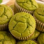 Green Muffins in a pile on a plate.