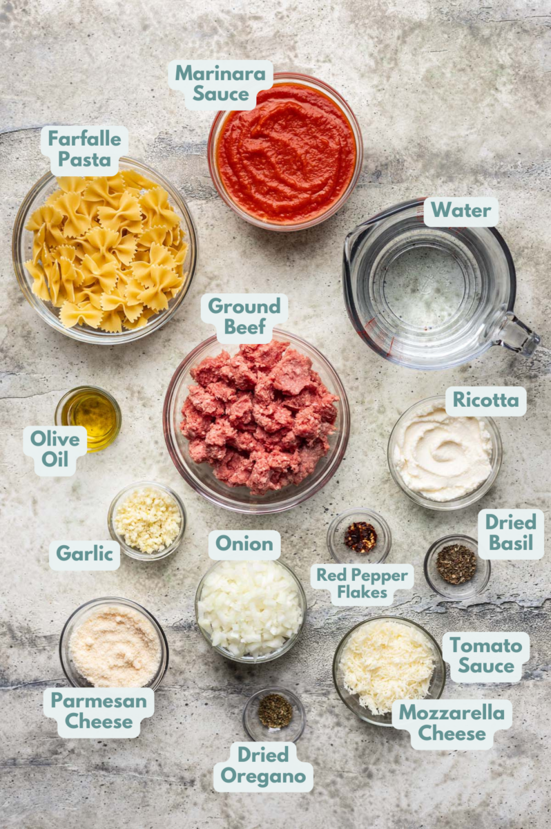 Labeled One Pot Lasagna Ingredients in bowls and measuring cups on a counter.