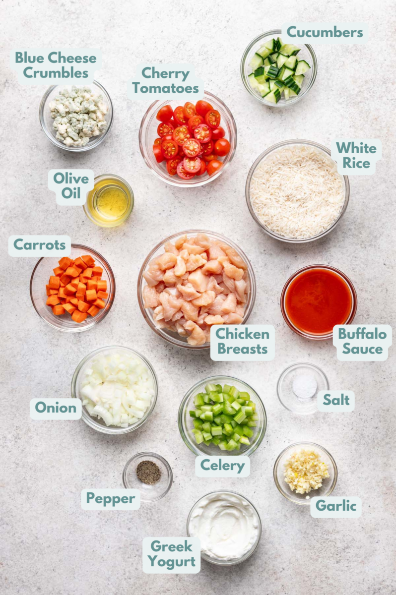 Labeled Buffalo Chicken Bowls Ingredients in bowls and measuring cups on a counter.