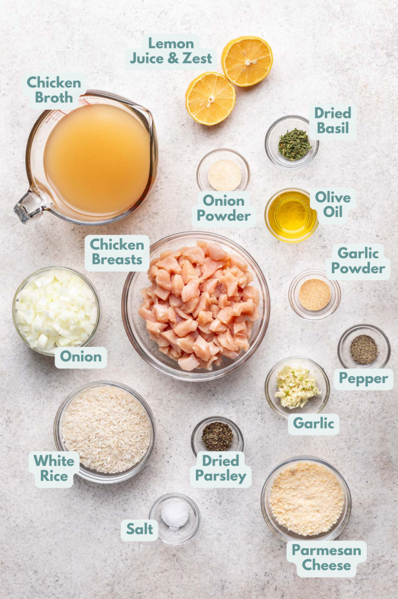 Labeled Lemon Parmesan Chicken & Rice Ingredients in bowls and measuring cups on a counter.