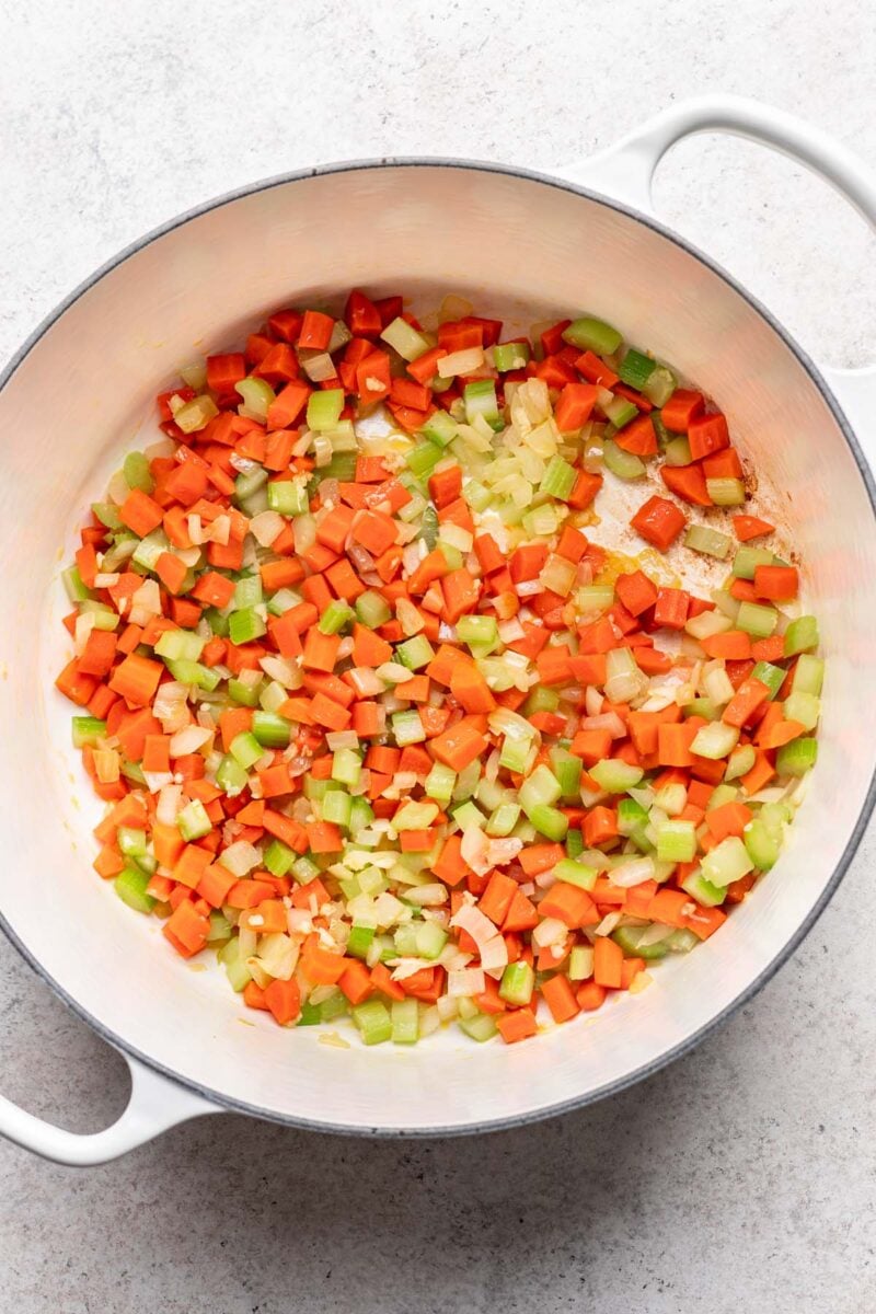 Carrots, celery, onion and garlic sauteing in a large dutch oven.