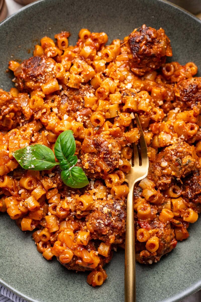 One Pot Meatball Pasta on a plate with a fork in it.