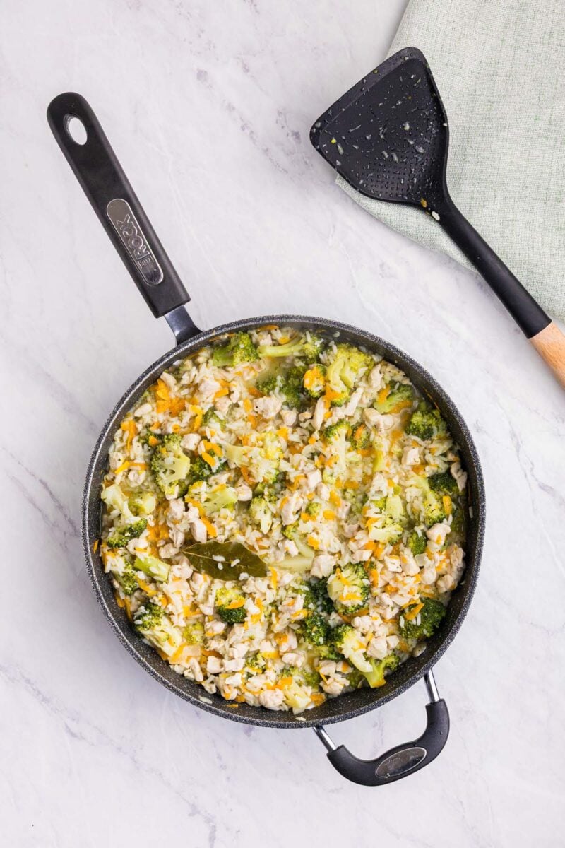 Broccoli chicken rice in a skillet before adding cheeses. 