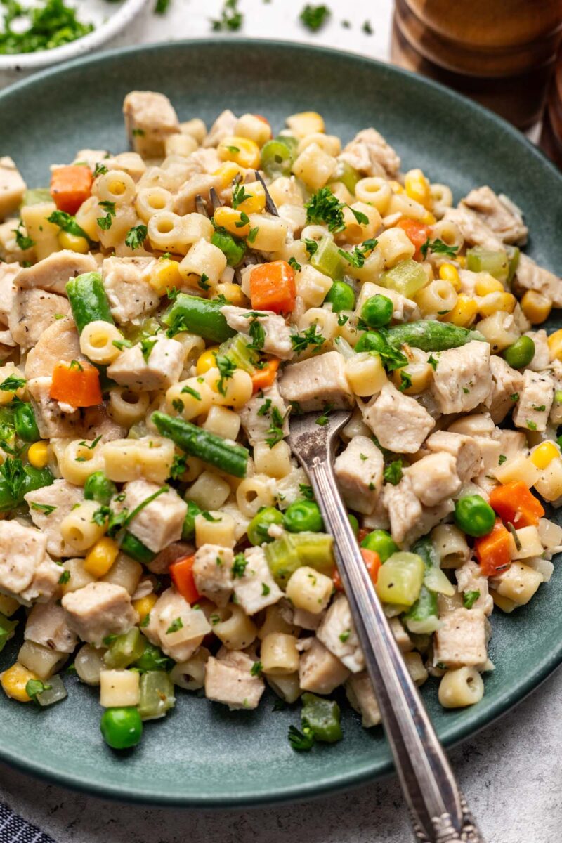 Chicken Pot Pie Pasta on a plate with a fork in it.