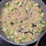One Pot Zucchini Orzo in a grey skillet