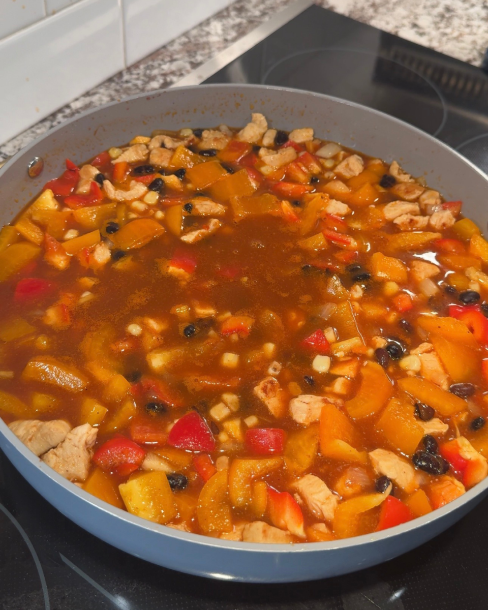chicken enchilada rice in a pan before it cooks